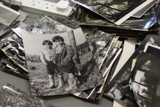 Black and white printed photos in a pile